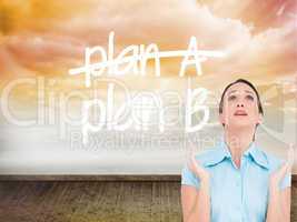 Composite image of concerned young businesswoman praying