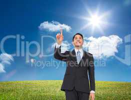 Composite image of smiling asian businessman pointing