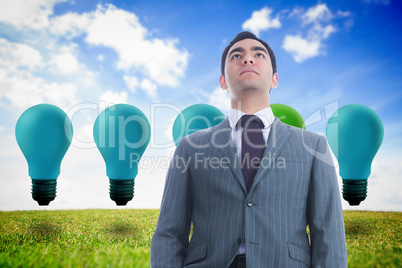 Composite image of unsmiling businessman standing