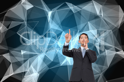 Composite image of thoughtful asian businessman pointing