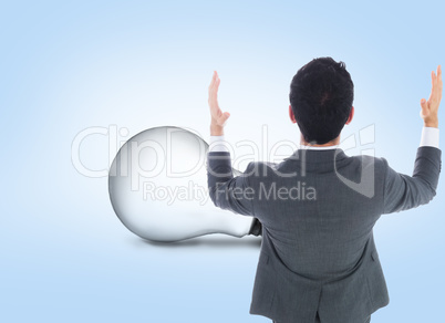 Composite image of businessman with arms raised