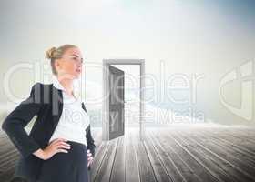 Composite image of businesswoman standing with hands on hips