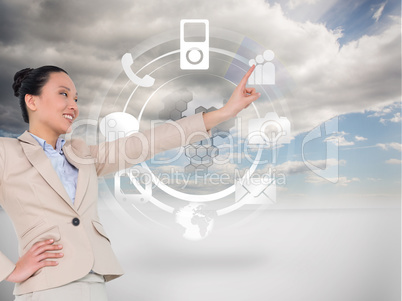 Composite image of smiling asian businesswoman pointing