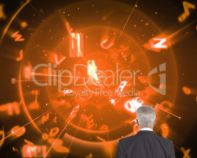 Composite image of businessman walking away from camera