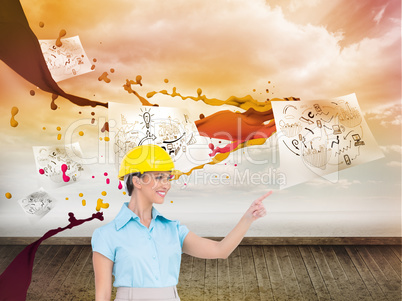 Composite image of smiling attractive architect pointing