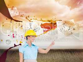 Composite image of smiling attractive architect pointing