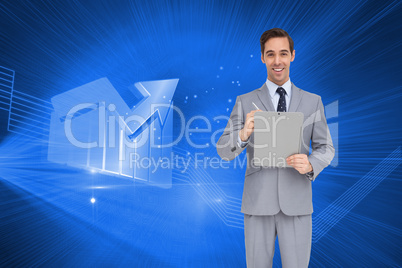 Composite image of happy businessman holding a clipboard