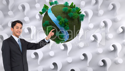 Composite image of smiling asian businessman pointing