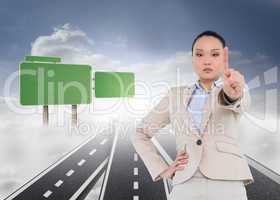 Composite image of unsmiling asian businesswoman pointing