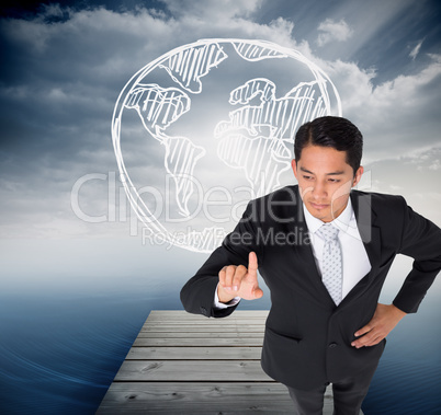 Composite image of unsmiling asian businessman pointing Composite image of unsmiling asian businessman pointing
