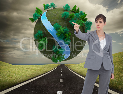 Composite image of young businesswoman pointing to something