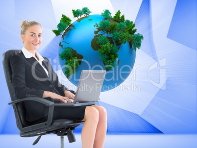 Composite image of businesswoman sitting in swivel chair with la