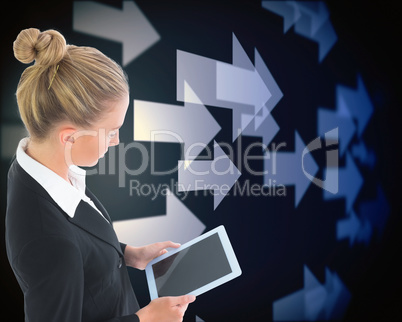 Composite image of businesswoman holding tablet