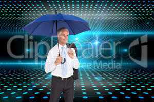 Composite image of happy businessman holding umbrella