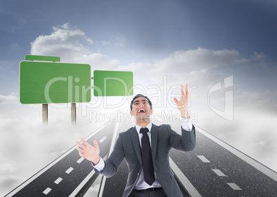 Composite image of excited businessman catching