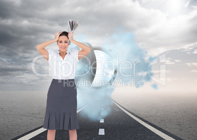 Composite image of worried stylish businesswoman holding newspap