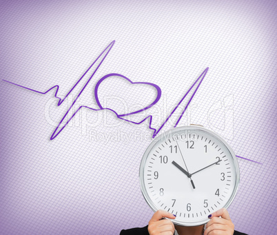 Composite image of businesswoman in suit holding a clock