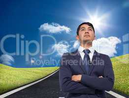 Composite image of unsmiling asian businessman with arms crossed