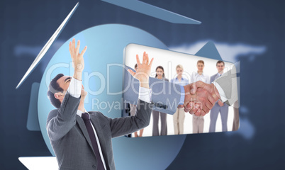 Composite image of unsmiling businessman with arms raised