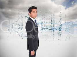 Composite image of serious businessman looking at camera