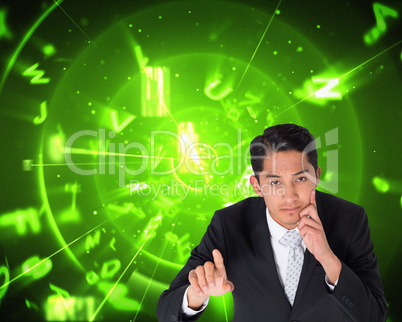 Composite image of thoughtful asian businessman pointing