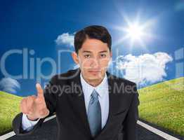 Composite image of serious asian businessman pointing