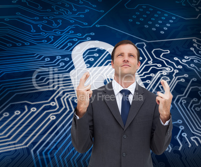 Composite image of serious businessman with fingers crossed is l