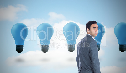 Composite image of unsmiling businessman standing