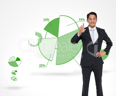 Composite image of smiling asian businessman pointing