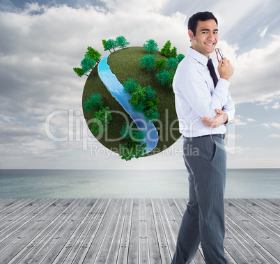 Composite image of smiling businessman holding glasses