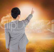 Composite image of asian businesswoman pointing