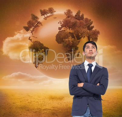 Composite image of unsmiling casual businessman with arms crosse