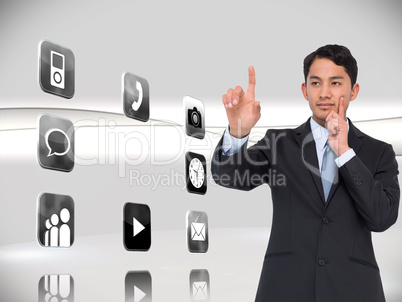 Composite image of thoughtful asian businessman pointing