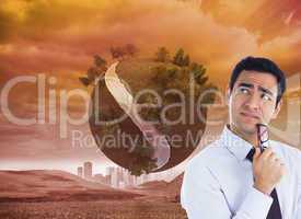 Composite image of thinking businessman holding glasses