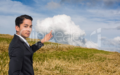 Composite image of unsmiling asian businessman pointing