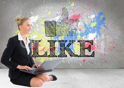 Composite image of businesswoman using laptop