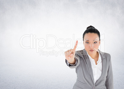 Composite image of unsmiling asian businesswoman pointing