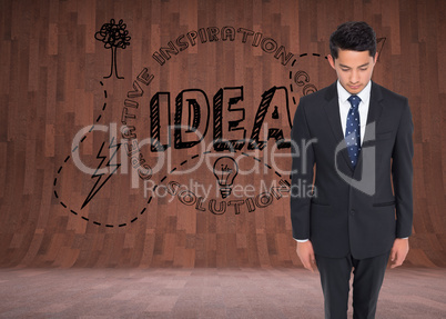 Composite image of serious businessman looking down