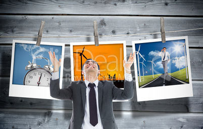 Composite image of happy  businessman with arms raised