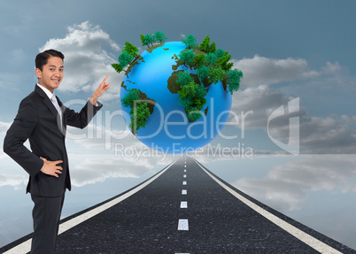 Composite image of smiling asian businessman pointing