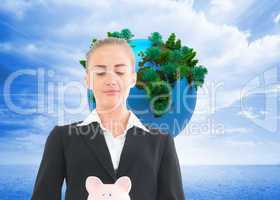 Composite image of businesswoman holding piggy bank