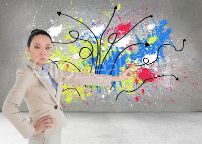 Composite image of unsmiling asian businesswoman pointing