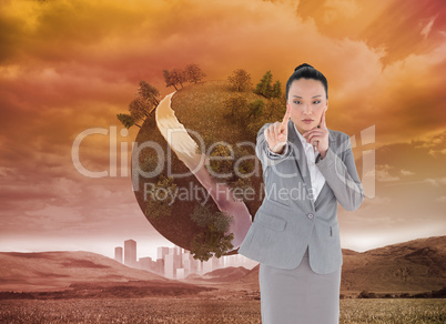 Composite image of thoughtful asian businesswoman pointing