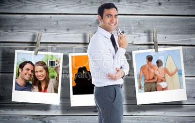 Composite image of smiling businessman holding glasses