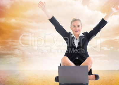 Composite image of businesswoman sitting in front of laptop with