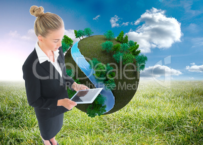 Composite image of businesswoman holding new tablet