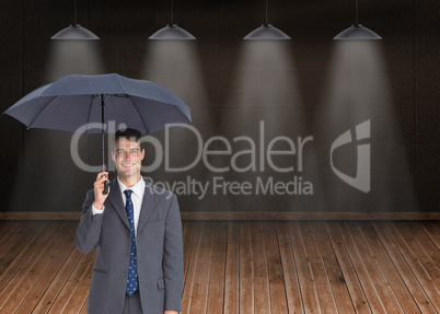 Composite image of happy businessman holding grey umbrella