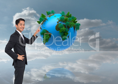 Composite image of smiling asian businessman pointing