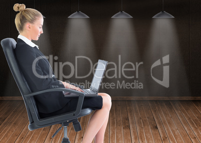 Composite image of businesswoman sitting on swivel chair with la