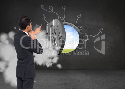 Composite image of thoughtful asian businessman pointing